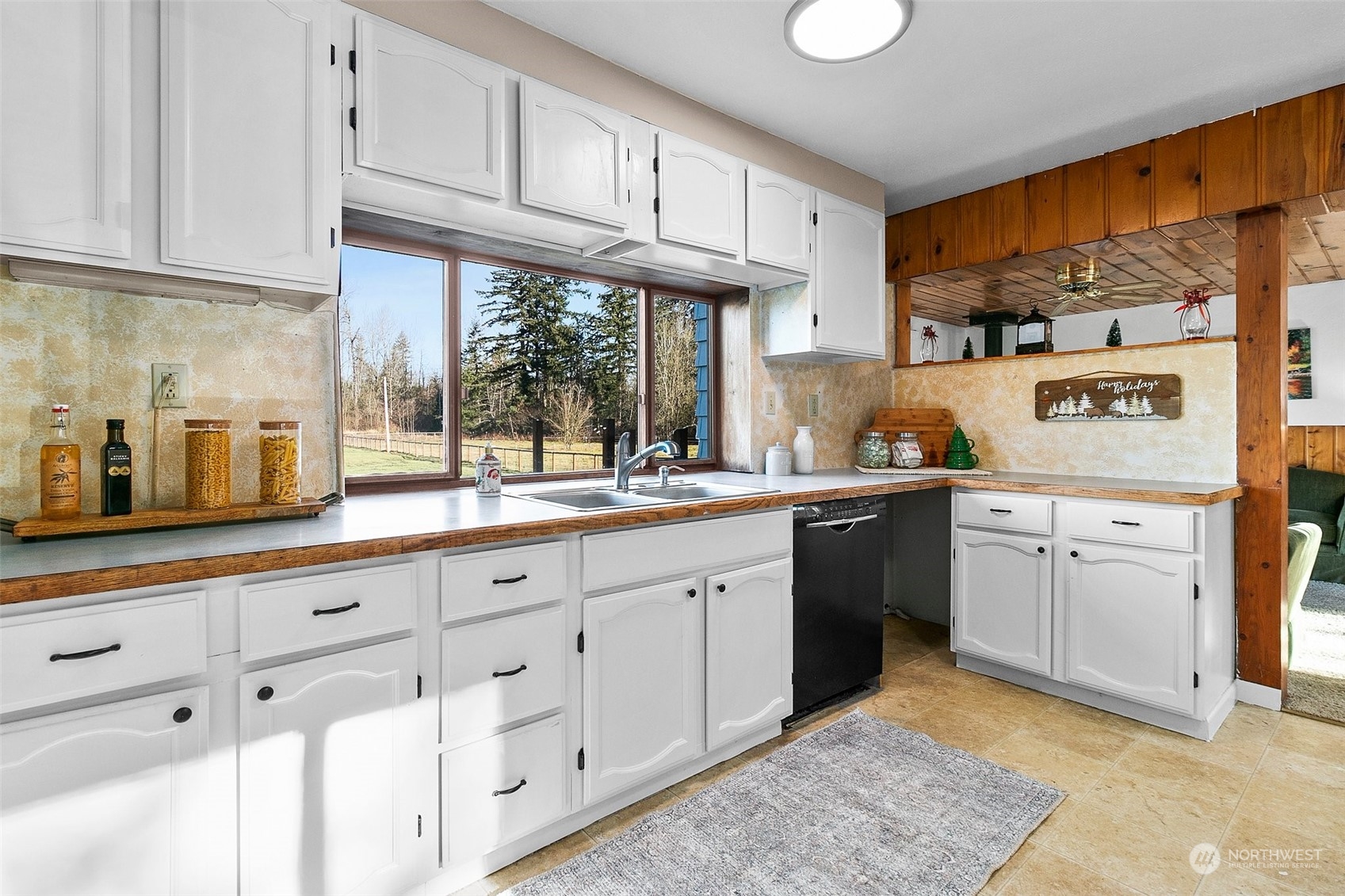 21650 Sweeney Road Southeast Maple Valley, WA 98038 - Photo 8 of 36 a kitchen with granite countertop a sink stainless steel appliances and cabinets