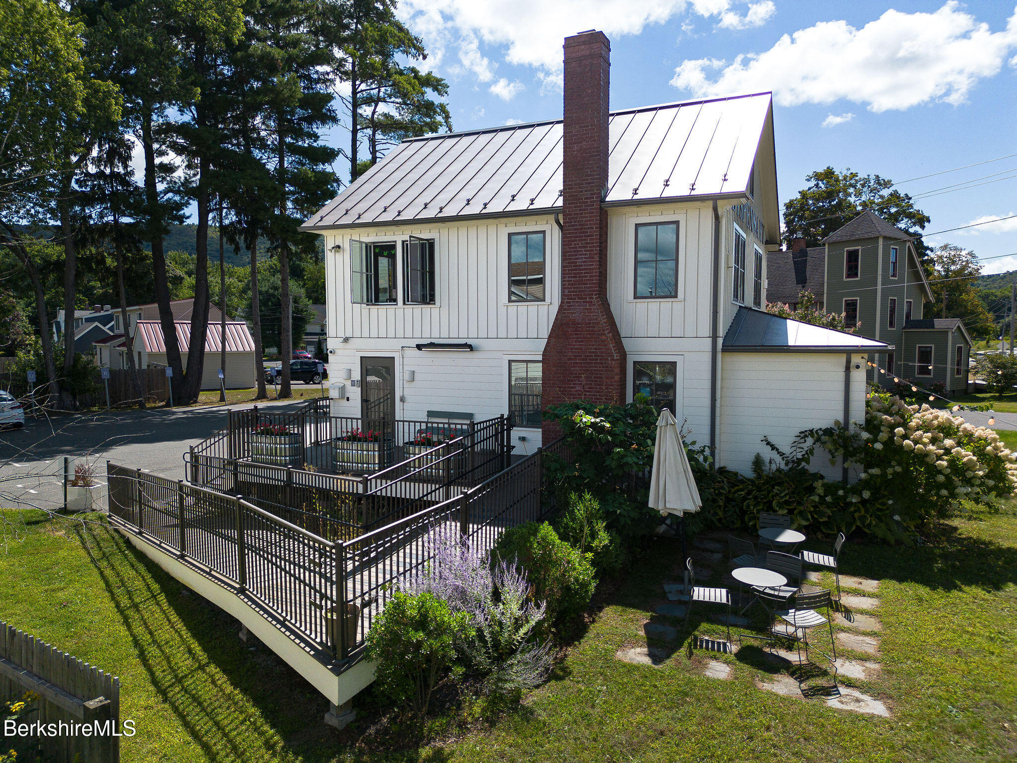 783 Main Street Great Barrington, MA 01230 - Photo 1 of 31 a view of a house with backyard sitting area and garden