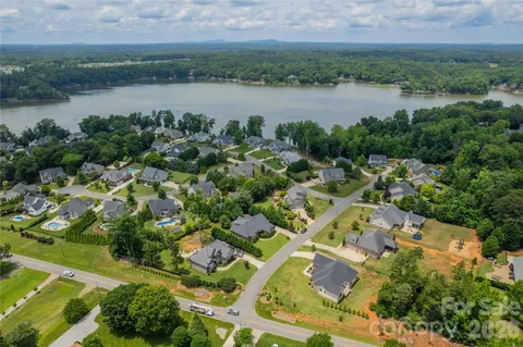 an aerial view of residential house with outdoor space and lake view