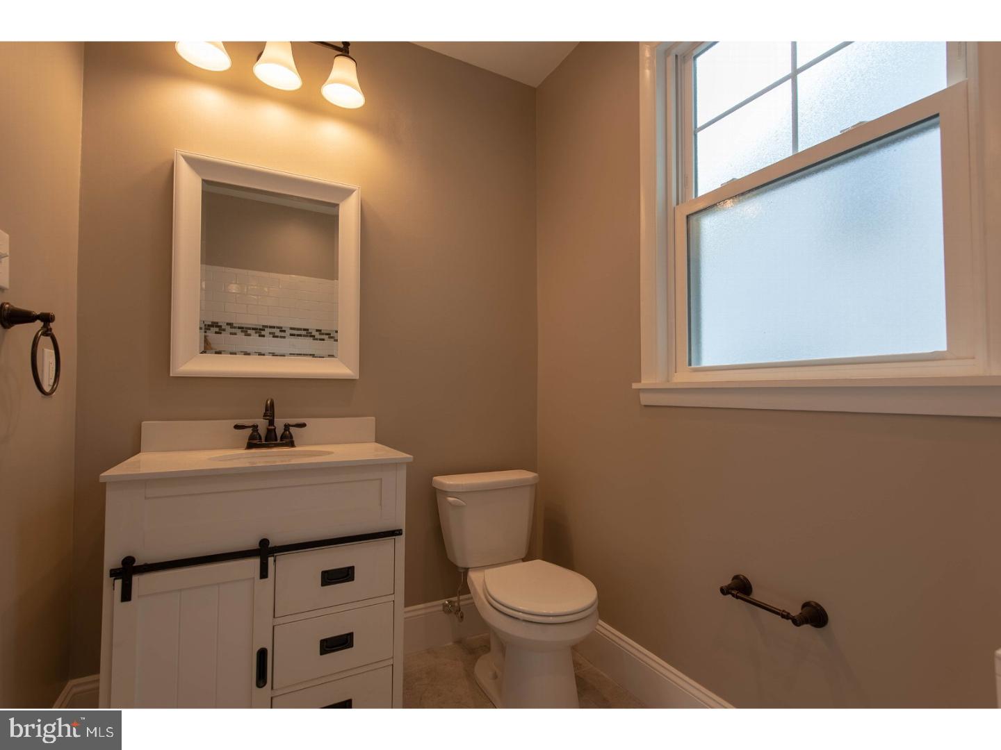 265 Orchard Road Springfield, PA 19064 - Photo 8 of 24 a bathroom with a toilet a sink and mirror