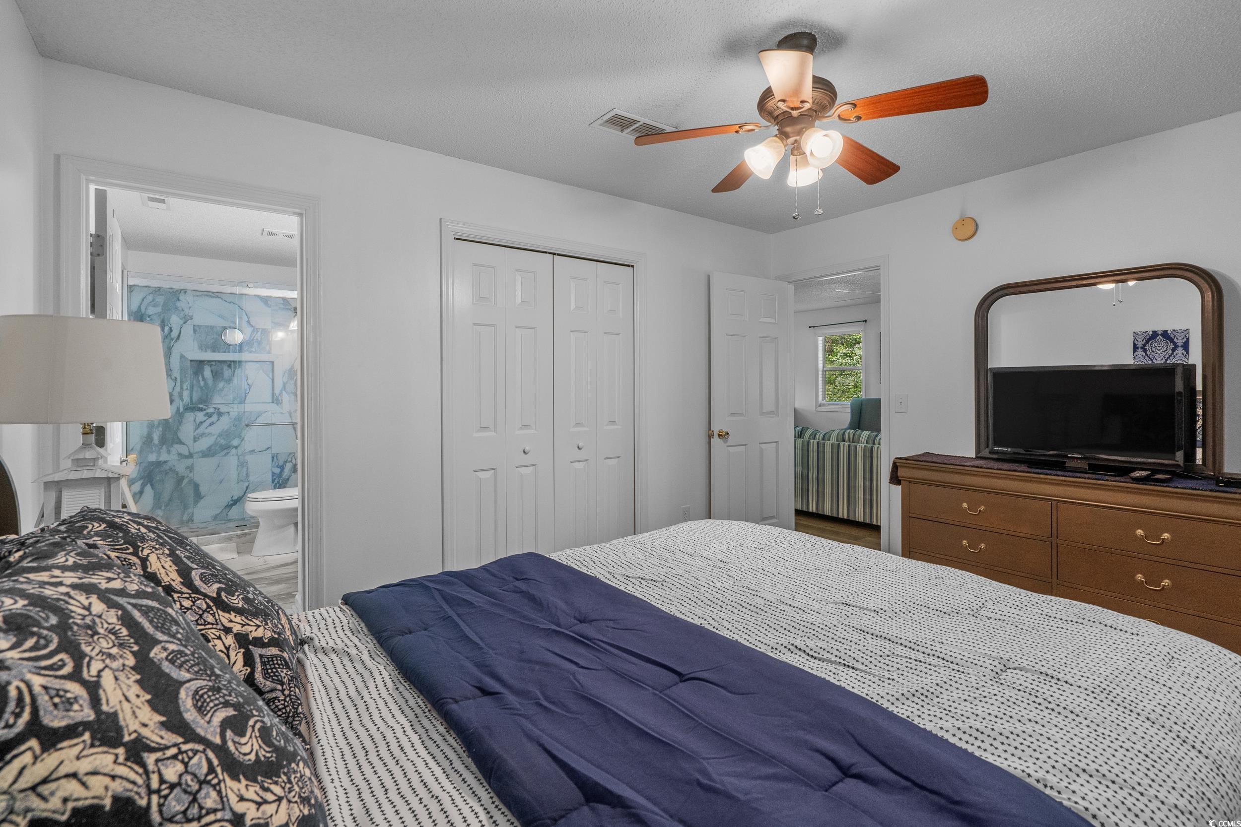 1290 White Tree Lane Myrtle Beach, SC 29588 - Photo 19 of 33 Back of property featuring a sunroom and a lawn