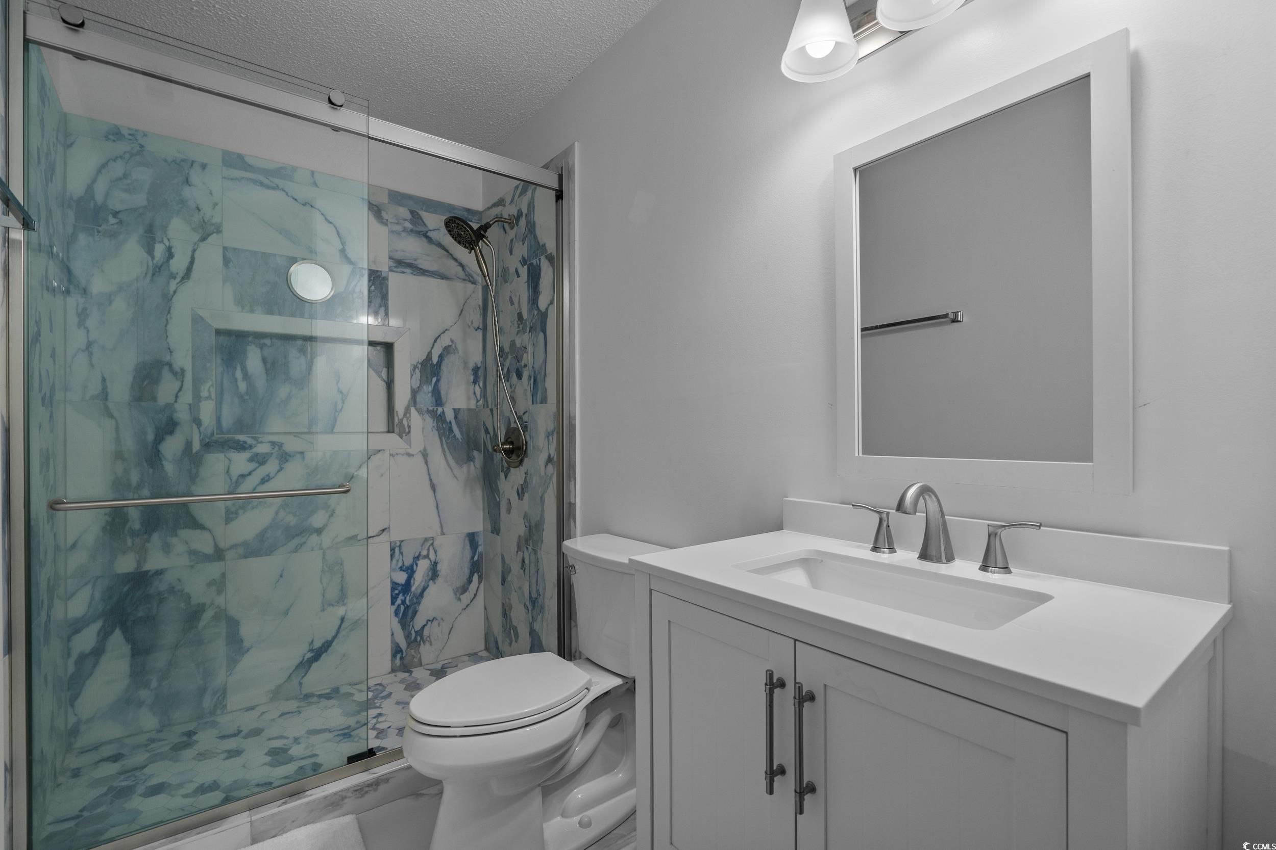 1290 White Tree Lane Myrtle Beach, SC 29588 - Photo 20 of 33 Bedroom featuring ceiling fan, a textured ceiling, and wood finished floors