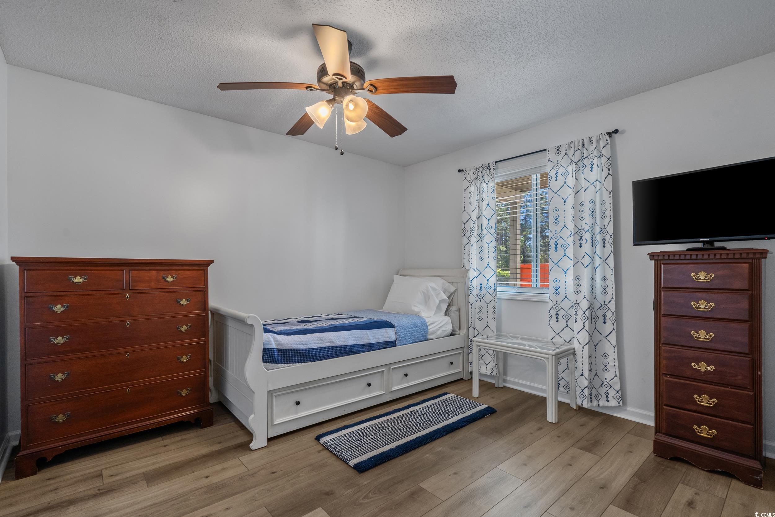 1290 White Tree Lane Myrtle Beach, SC 29588 - Photo 21 of 33 Bedroom with wood finished floors, a textured ceiling, and a ceiling fan