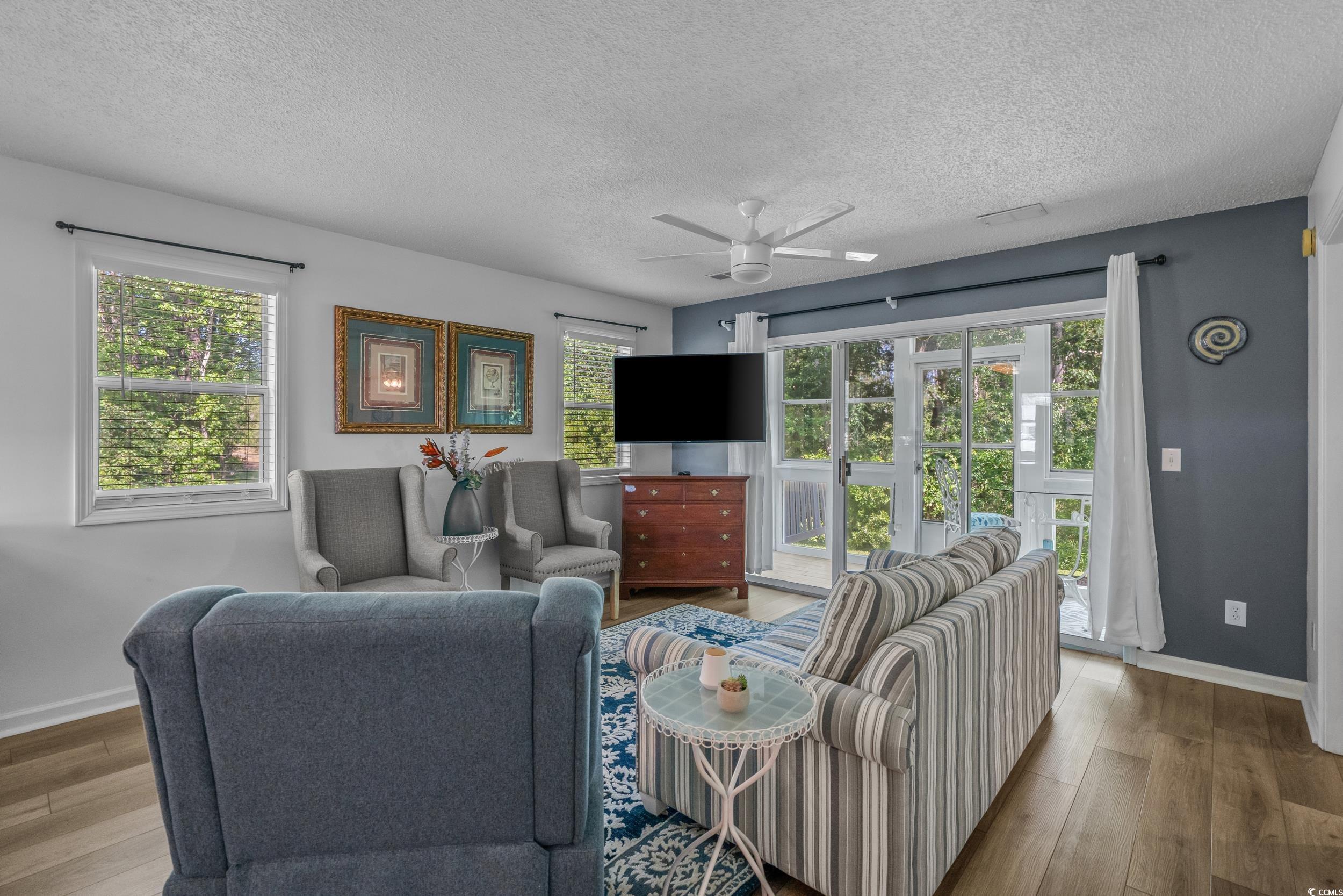 1290 White Tree Lane Myrtle Beach, SC 29588 - Photo 6 of 33 Hallway with a textured ceiling and dark wood finished floors