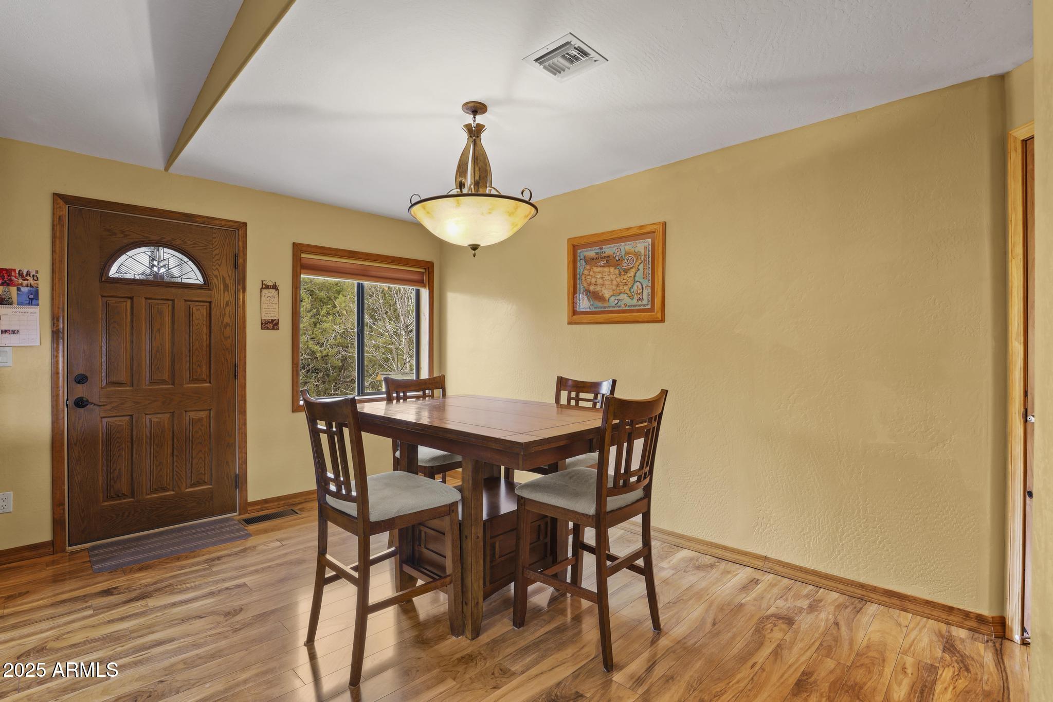 804 East Phoenix Street Payson, AZ 85541 - Photo 17 of 56 a view of a dining room with furniture and wooden floor