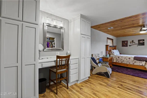 a bedroom with a bed and wooden floor