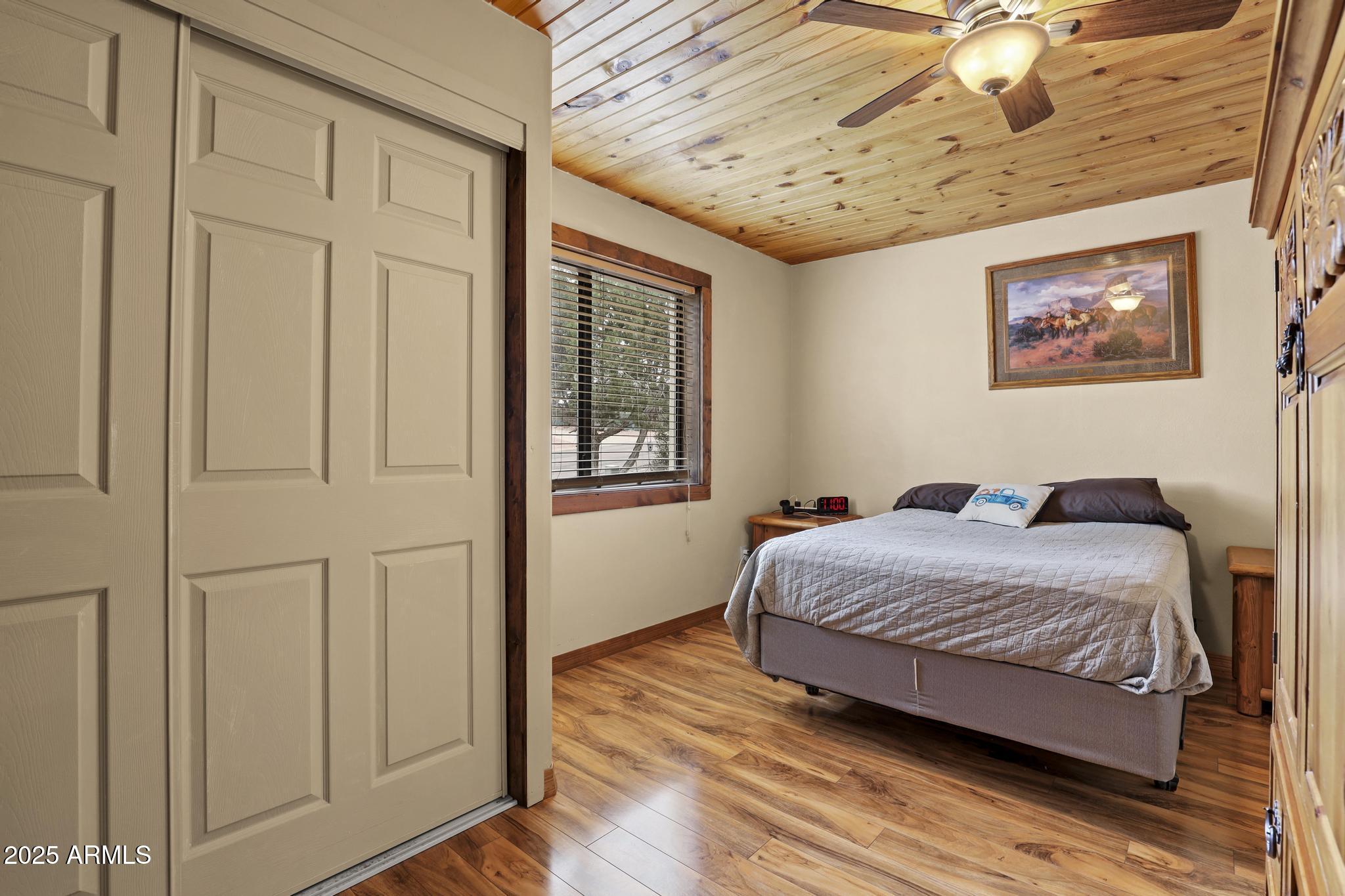 804 East Phoenix Street Payson, AZ 85541 - Photo 25 of 56 a bedroom with a bed and a chandelier