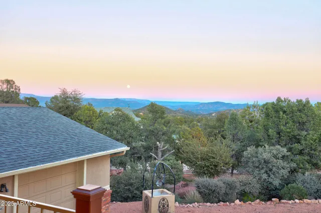 a view of a house with a yard and mountain