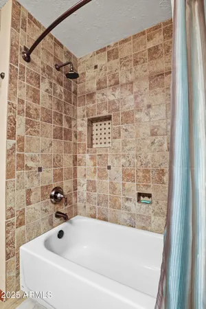 a room with furniture pool table and paintings on the wall