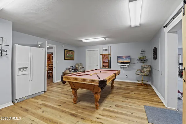 a kitchen with white cabinets and window
