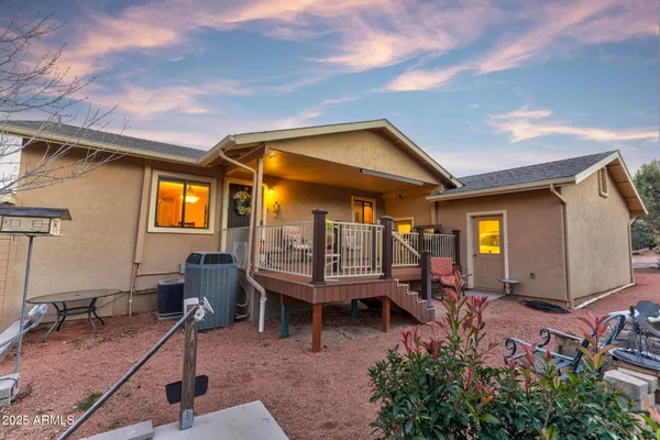 a view of a hallway with couch and chairs