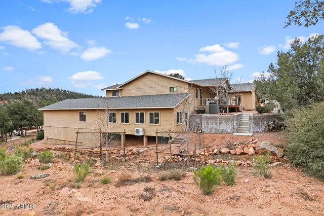 a front view of a house with basket ball court and a garage