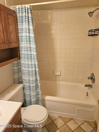 a bathroom with a toilet and a bathtub