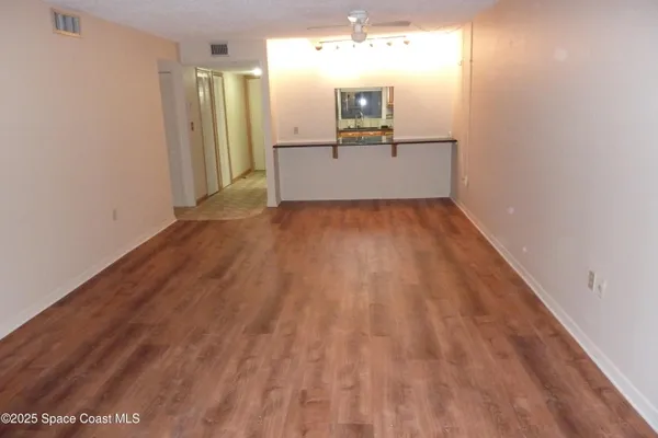 a view of a living room with a wooden floor