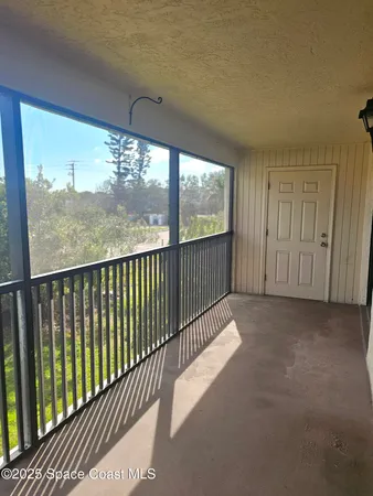 a view of a balcony with wooden floor