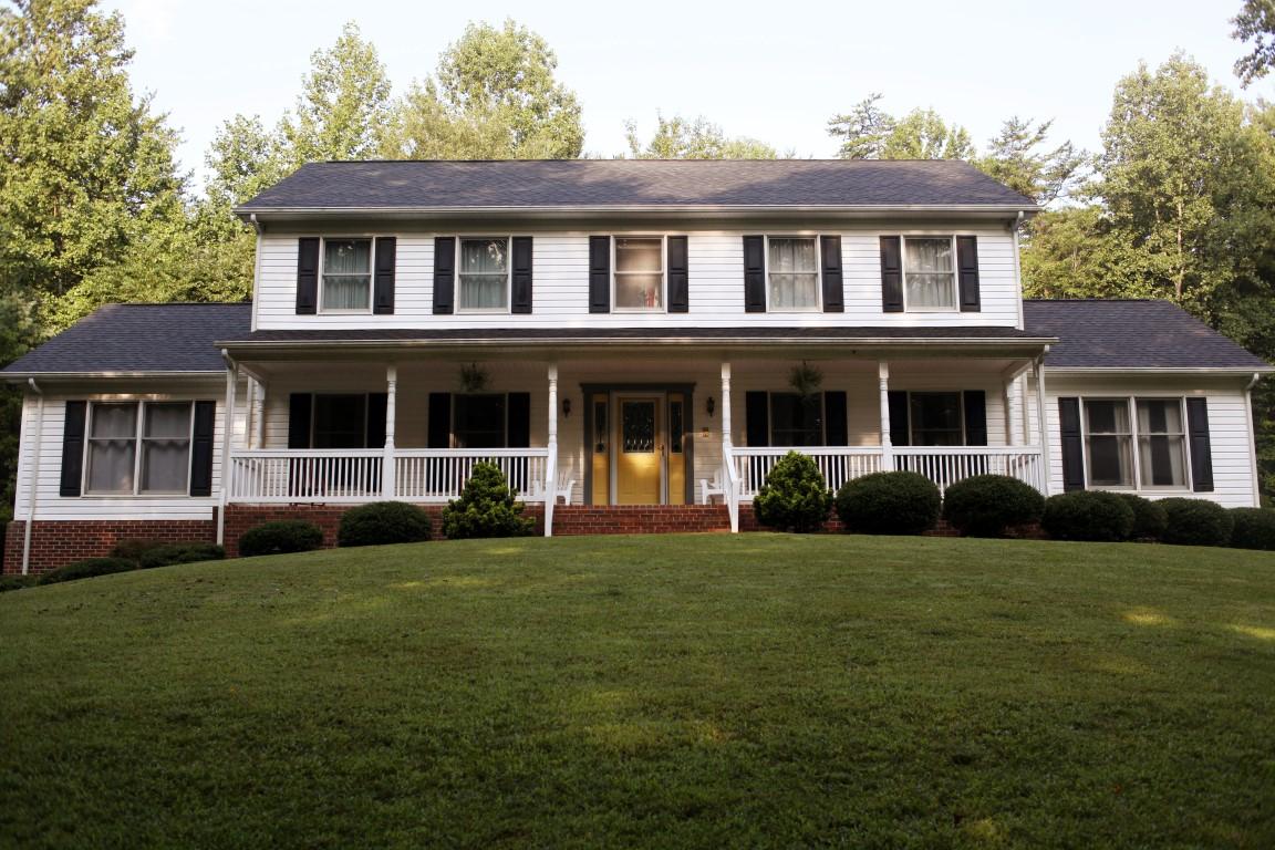 a front view of a house with a garden
