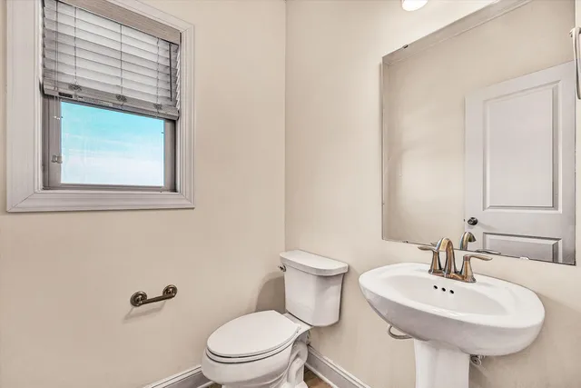 a bathroom with a sink a mirror and a toilet