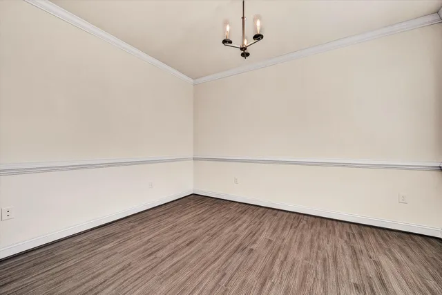 a view of a room with wooden floor