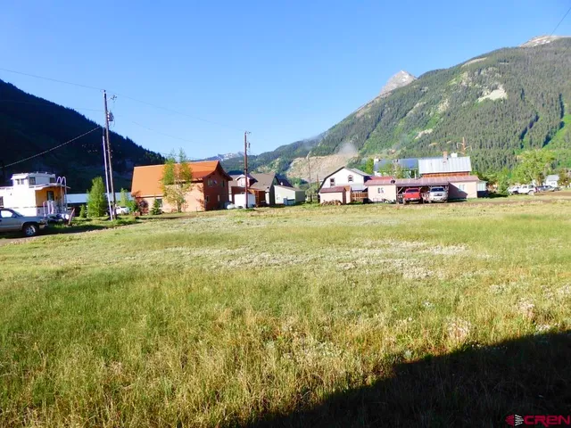 a view of a big yard with an outdoor seating