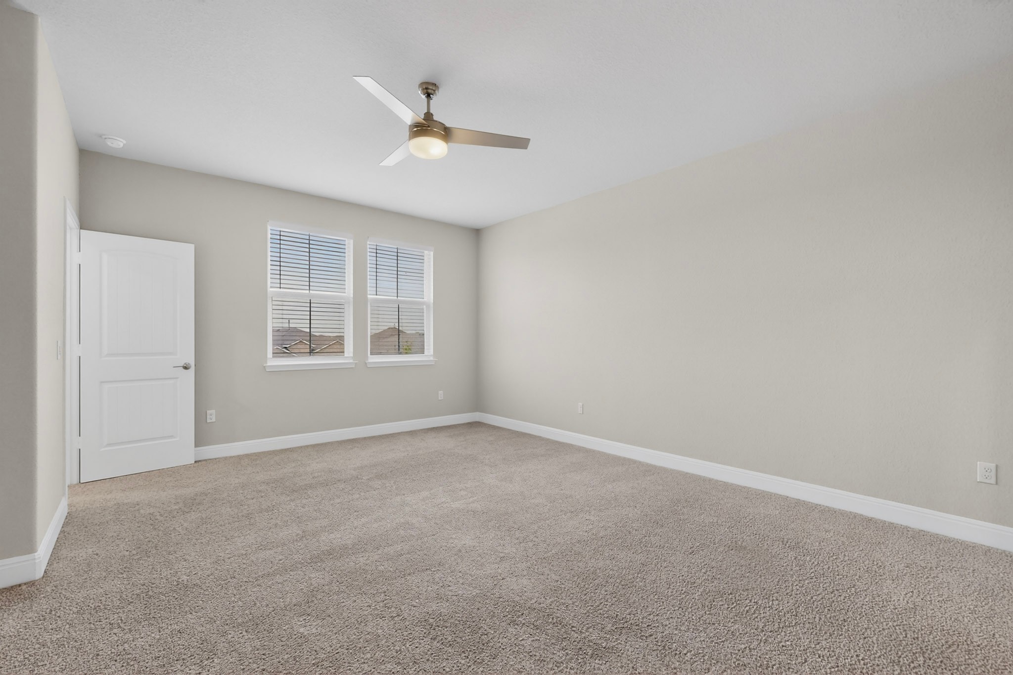 16809 Guido Cove Pflugerville, TX 78660 - Photo 15 of 40 Spacious room featuring neutral carpeting, light gray wall paint, and white trim