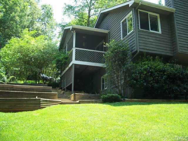 6624 Coach Light Circle Raleigh, NC 27613 - Photo 5 of 10 a view of backyard with potted plants and a large tree