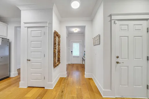 a large white kitchen with lots of counter top space and living room
