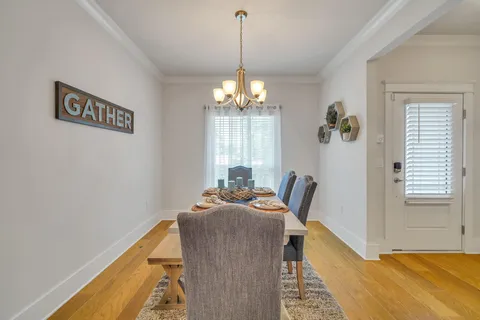 a open kitchen with stainless steel appliances granite countertop a stove a sink a refrigerator dining table and chairs