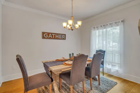 a kitchen with kitchen island white cabinets and stainless steel appliances