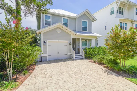 a view of a house with a yard and plants
