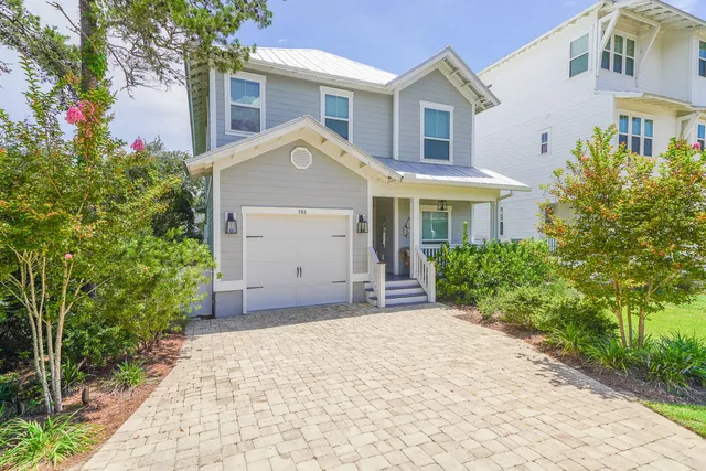 a view of a house with a yard and plants