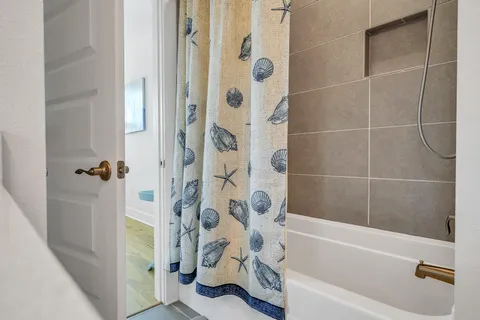 a bathroom with a shower curtain and a bathtub