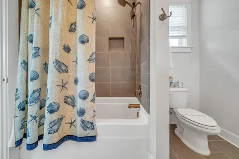 a bathroom with a sink toilet tub and shower