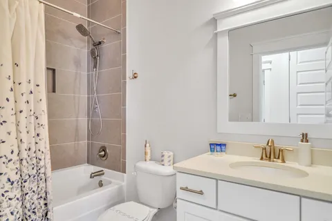 an aerial view of residential houses with outdoor space and trees