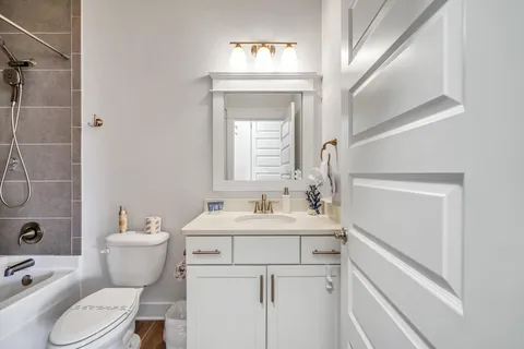 an aerial view of residential houses with outdoor space and lake view