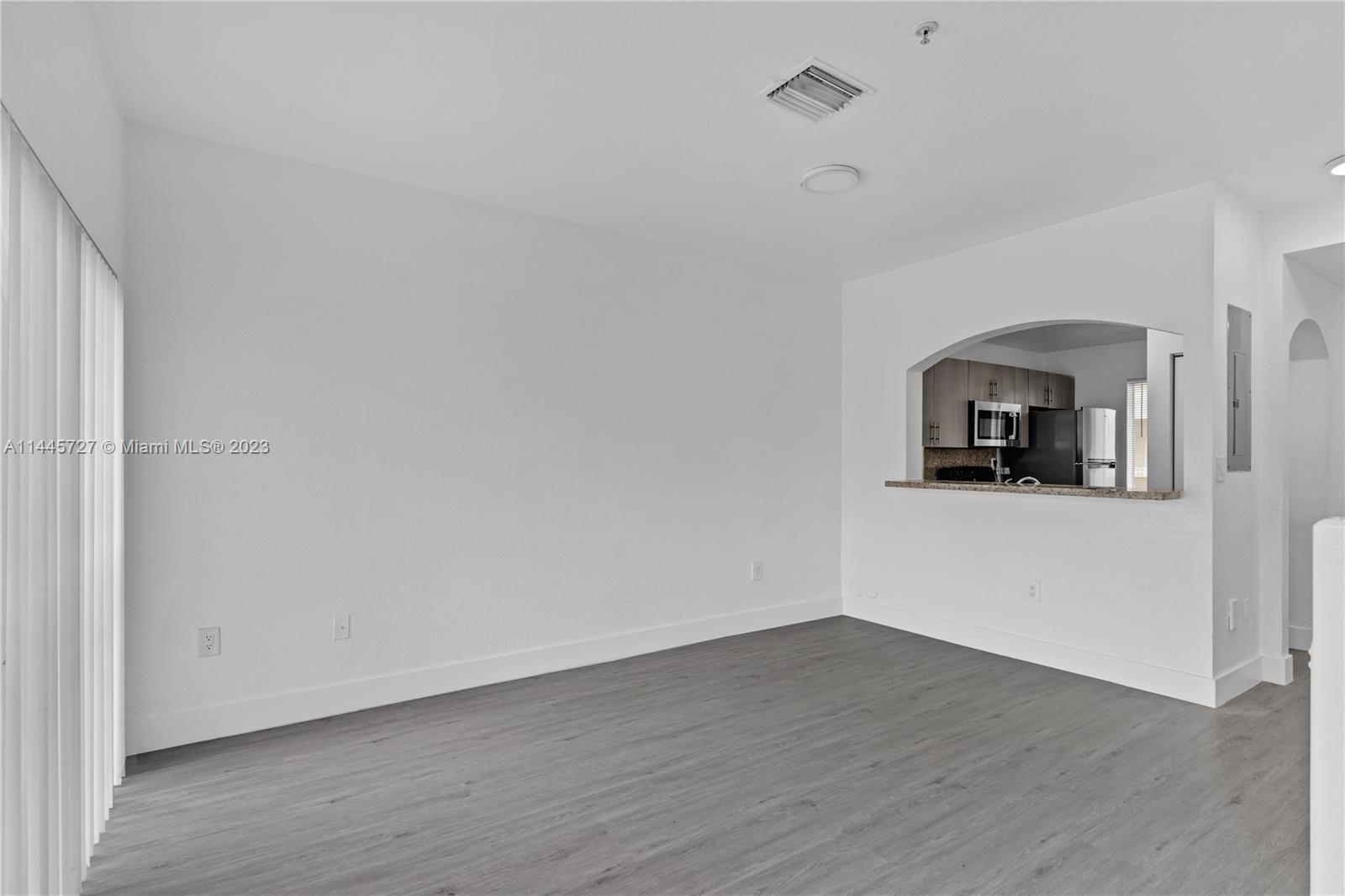 7989 Northwest 8th Street, Unit 110 Miami, FL 33126 - Photo 14 of 24 a view of a livingroom with wooden floor and a hallway