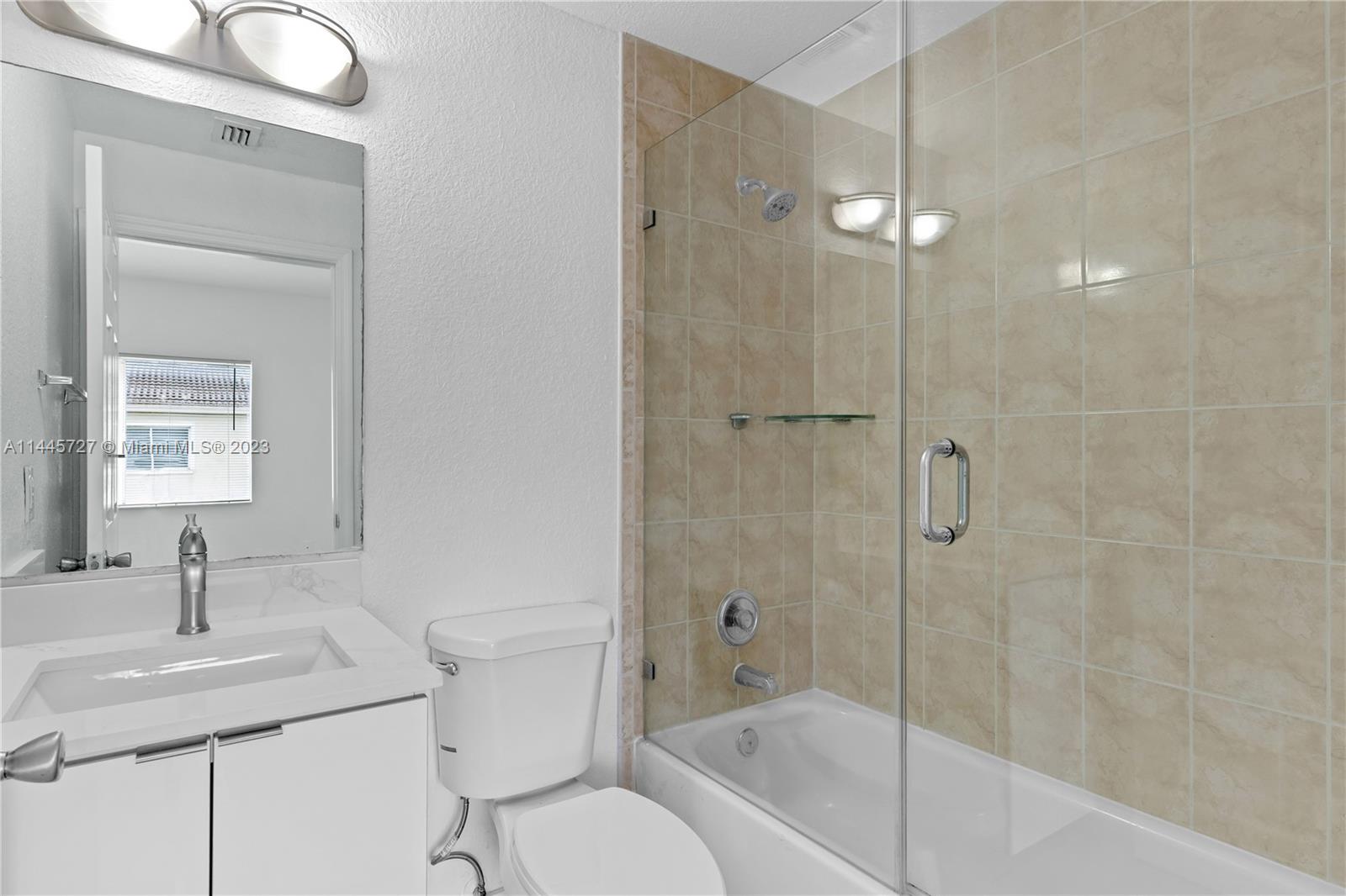 7989 Northwest 8th Street, Unit 110 Miami, FL 33126 - Photo 18 of 24 a bathroom with a sink a toilet and shower