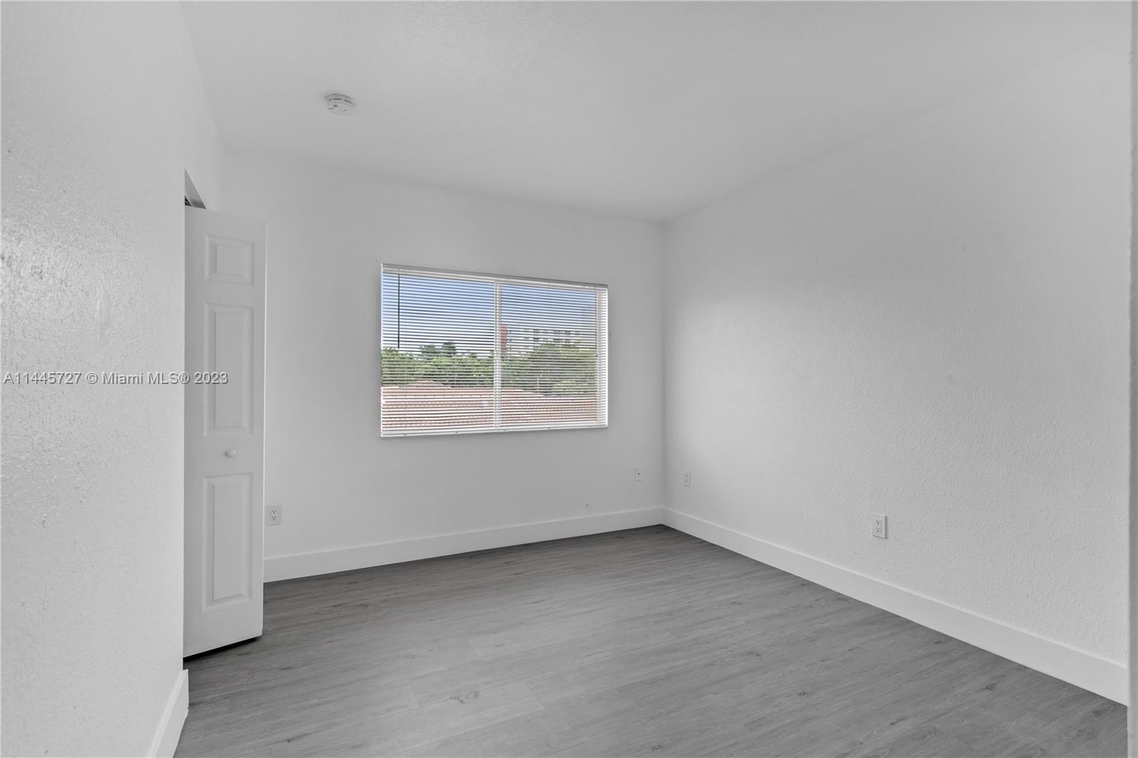 7989 Northwest 8th Street, Unit 110 Miami, FL 33126 - Photo 20 of 24 an empty room with windows