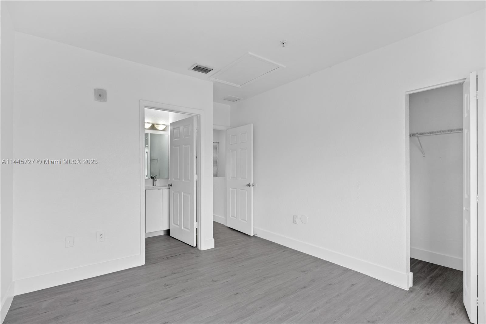 7989 Northwest 8th Street, Unit 110 Miami, FL 33126 - Photo 22 of 24 a view of an empty room with wooden floor