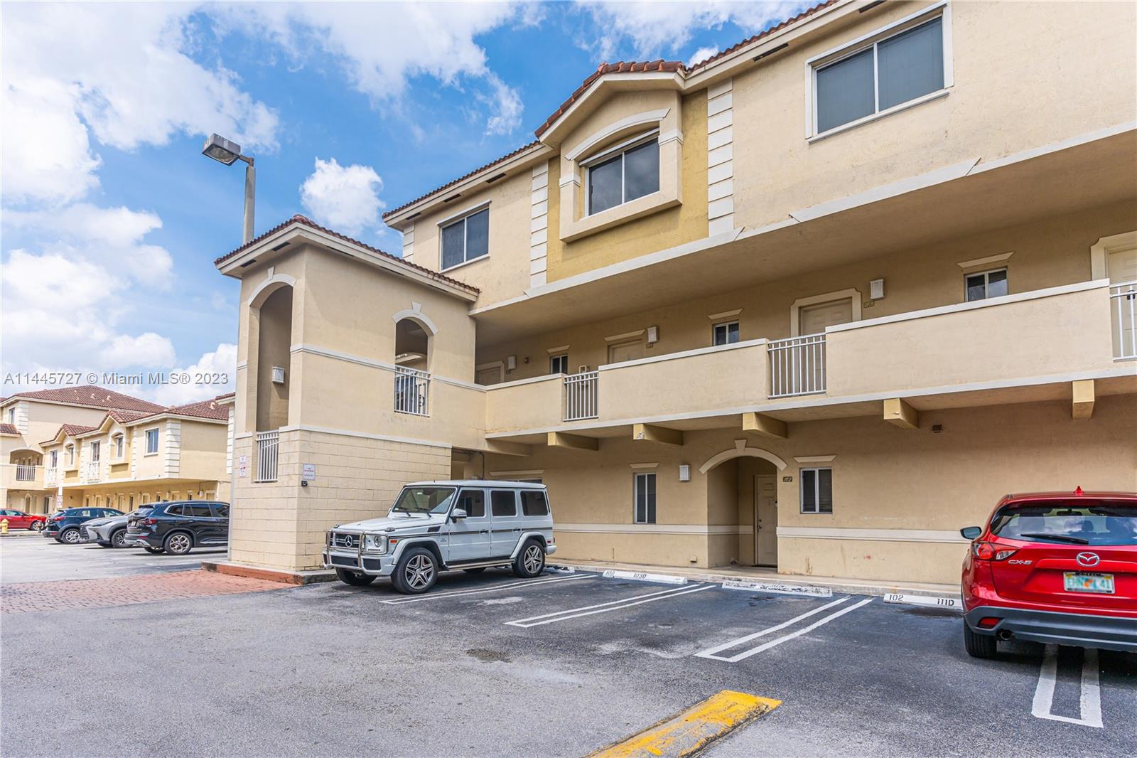 7989 Northwest 8th Street, Unit 110 Miami, FL 33126 - Photo 5 of 24 a view of a car park in front of house