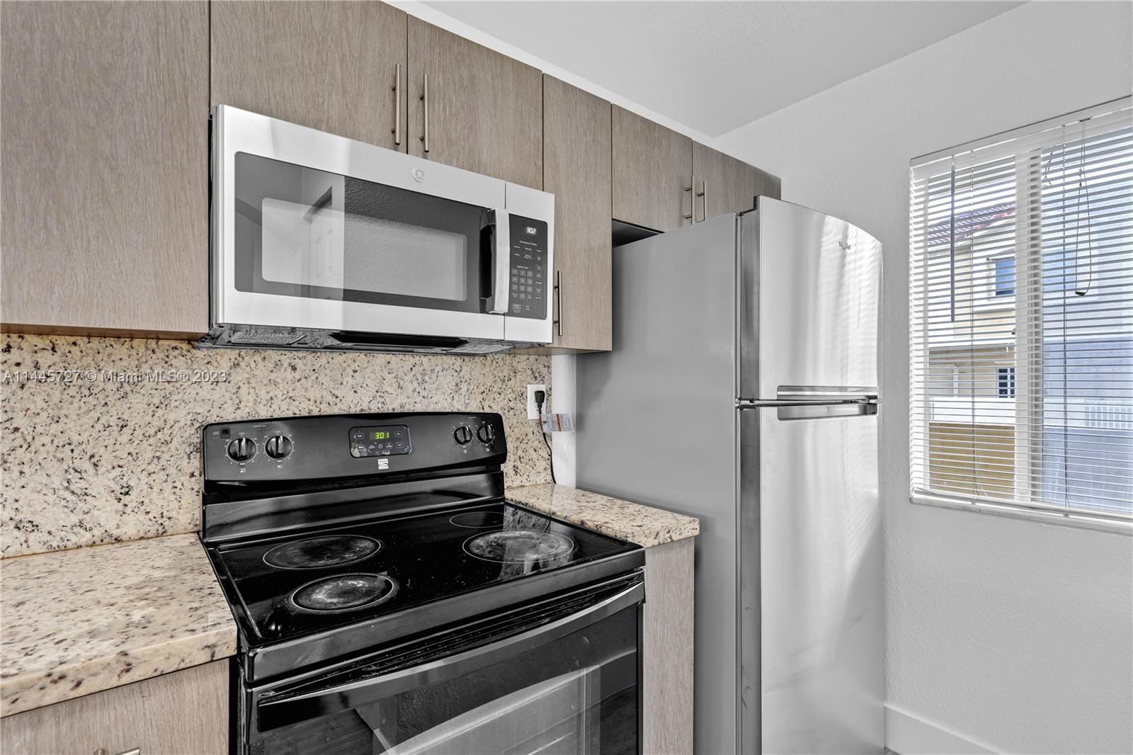 7989 Northwest 8th Street, Unit 110 Miami, FL 33126 - Photo 8 of 24 a kitchen with appliances and a microwave