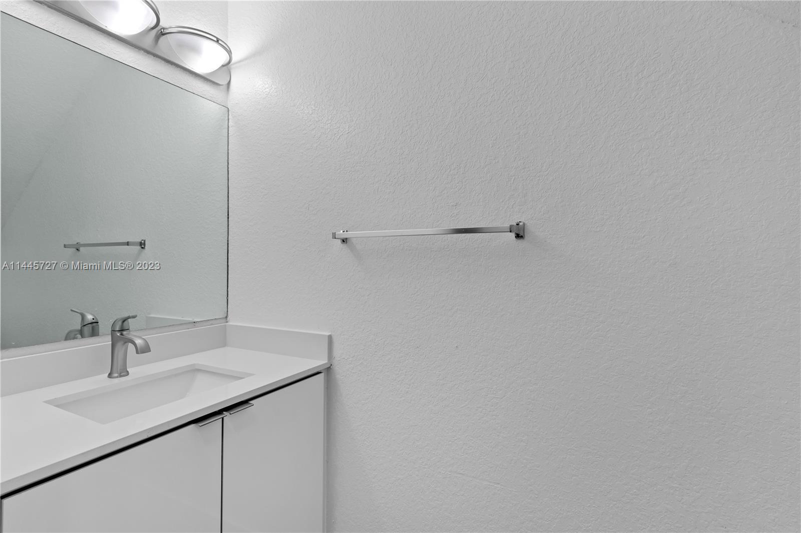 7989 Northwest 8th Street, Unit 110 Miami, FL 33126 - Photo 10 of 24 a bathroom with a sink and a mirror
