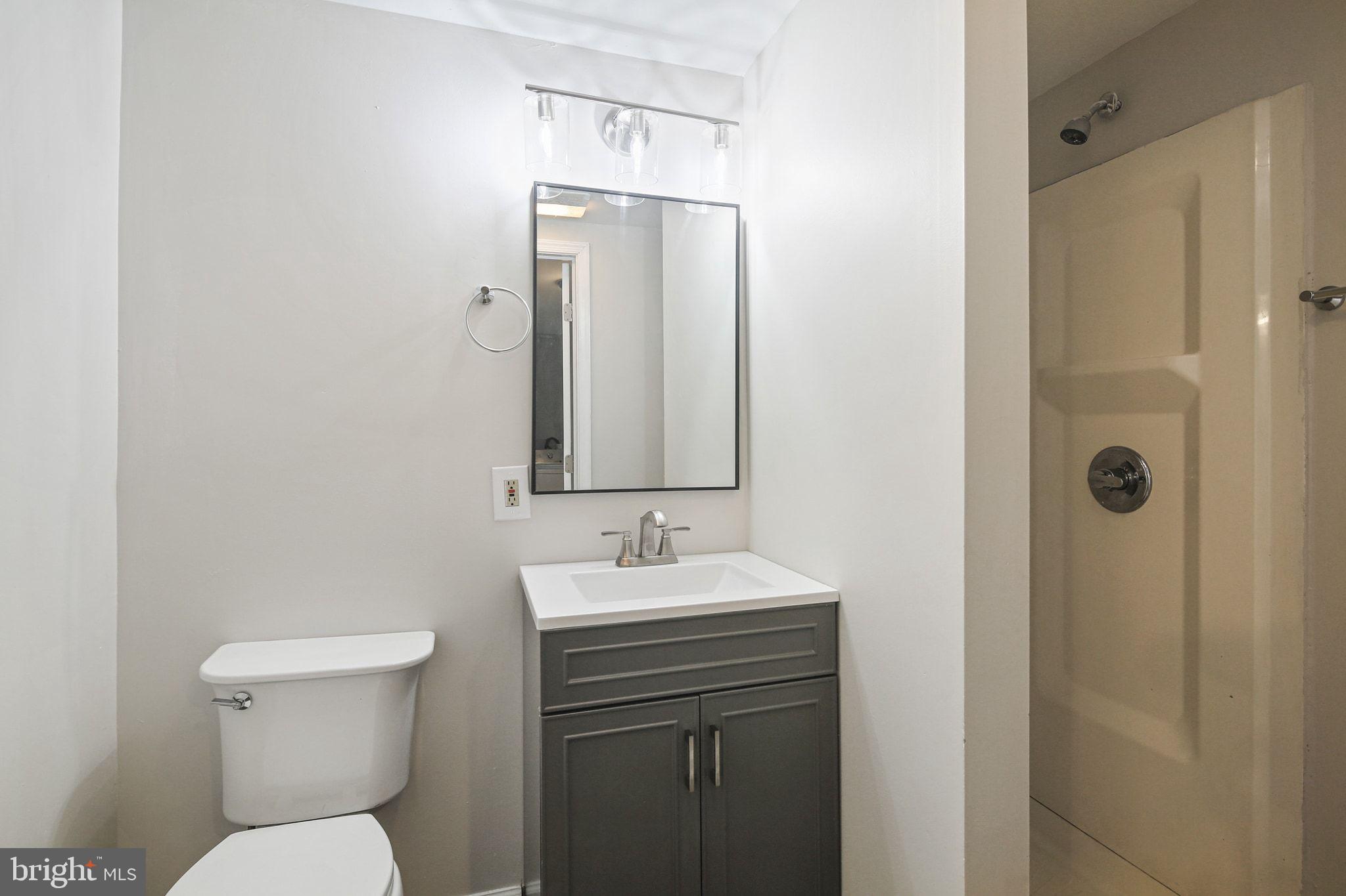 8209 Stewarton Court Severn, MD 21144 - Photo 32 of 34 a bathroom with a toilet sink and shower