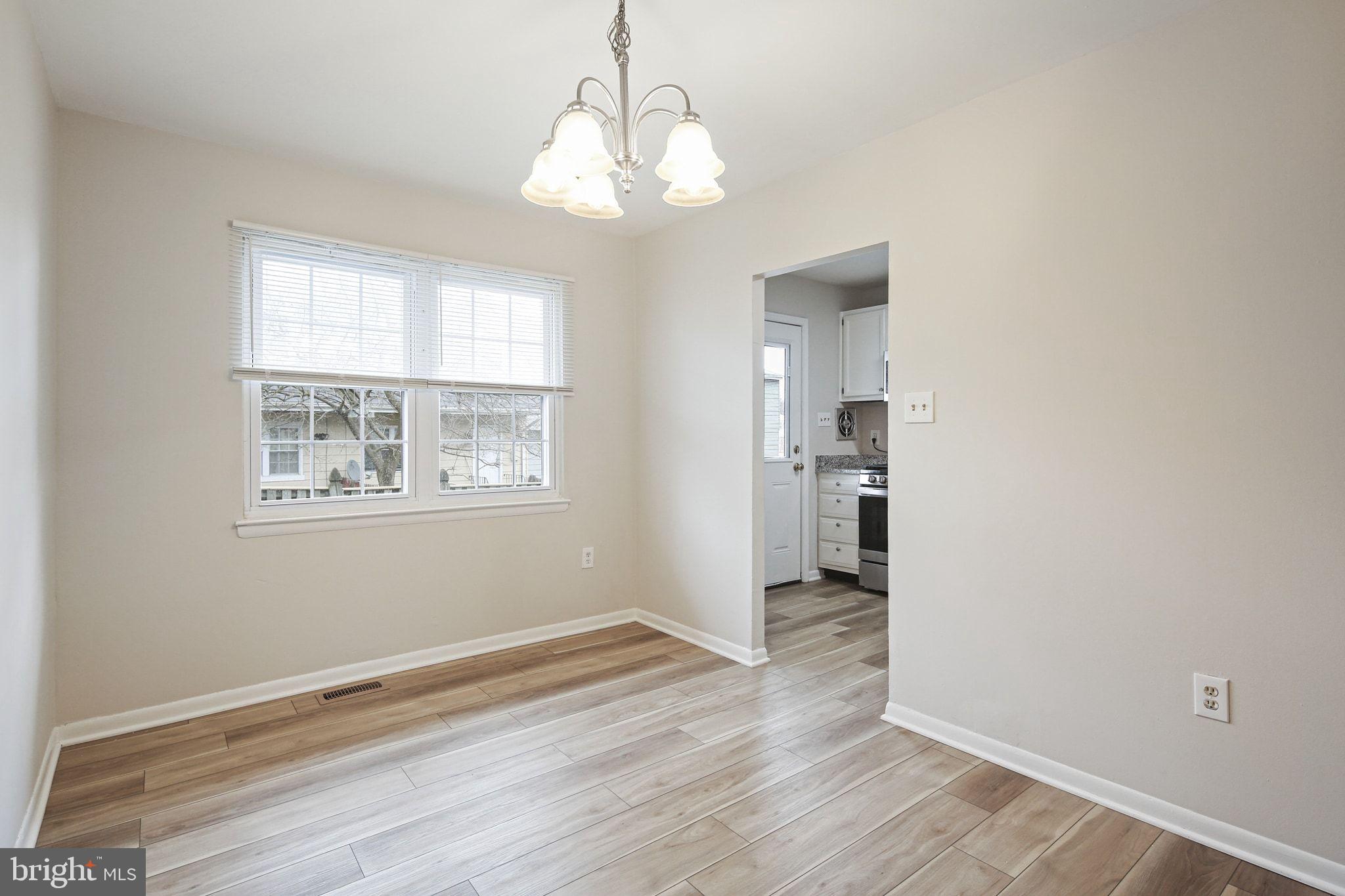 8209 Stewarton Court Severn, MD 21144 - Photo 9 of 34 an empty room with wooden floor and windows