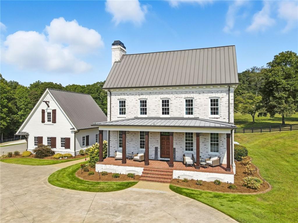 2229 Long Road Ball Ground, GA 30107 - Photo 1 of 88 a front view of a house with swimming pool having outdoor seating