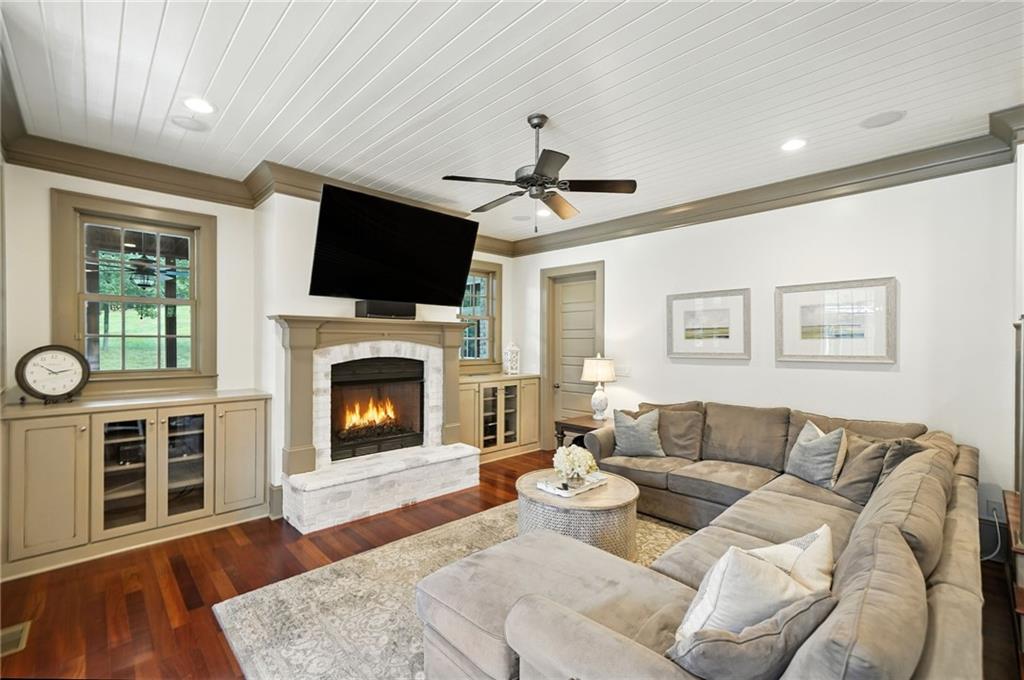 2229 Long Road Ball Ground, GA 30107 - Photo 27 of 88 a living room with furniture a flat screen tv and a fireplace