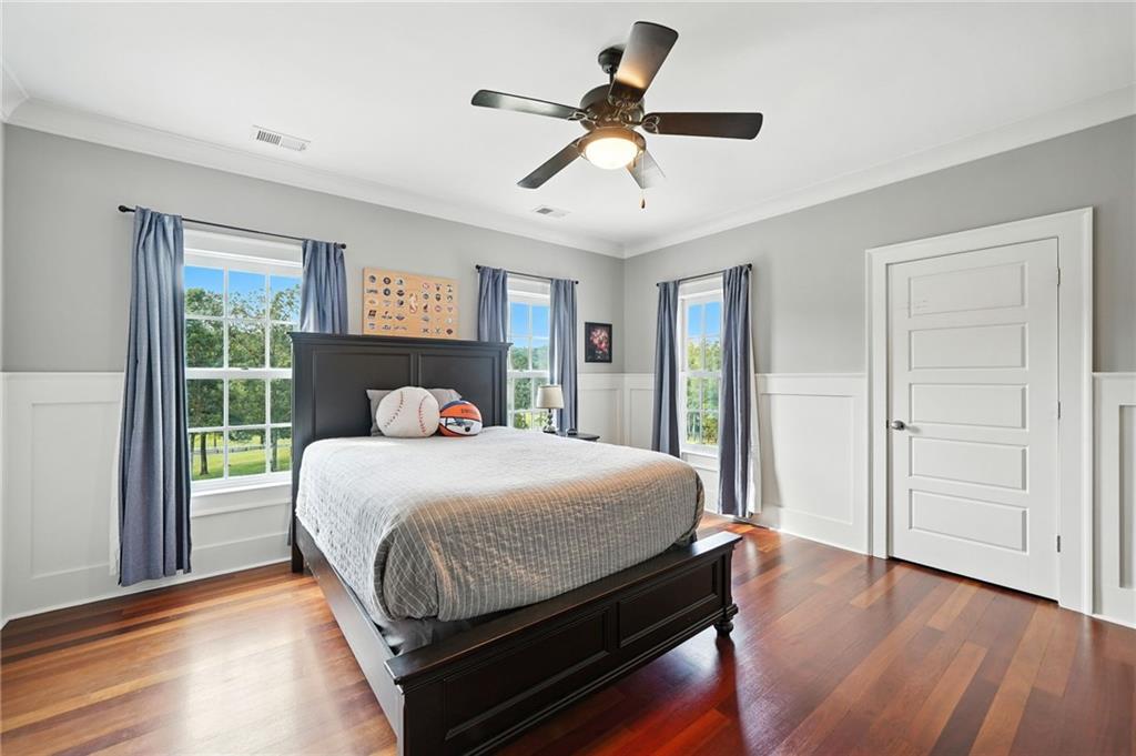2229 Long Road Ball Ground, GA 30107 - Photo 48 of 88 a bedroom with a bed and wooden floor