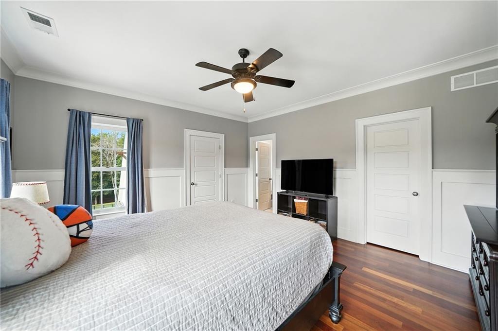 2229 Long Road Ball Ground, GA 30107 - Photo 49 of 88 a bedroom with a bed and wooden floor