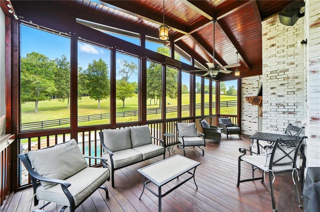 2229 Long Road Ball Ground, GA 30107 - Photo 60 of 88 a living room with furniture and a floor to ceiling window