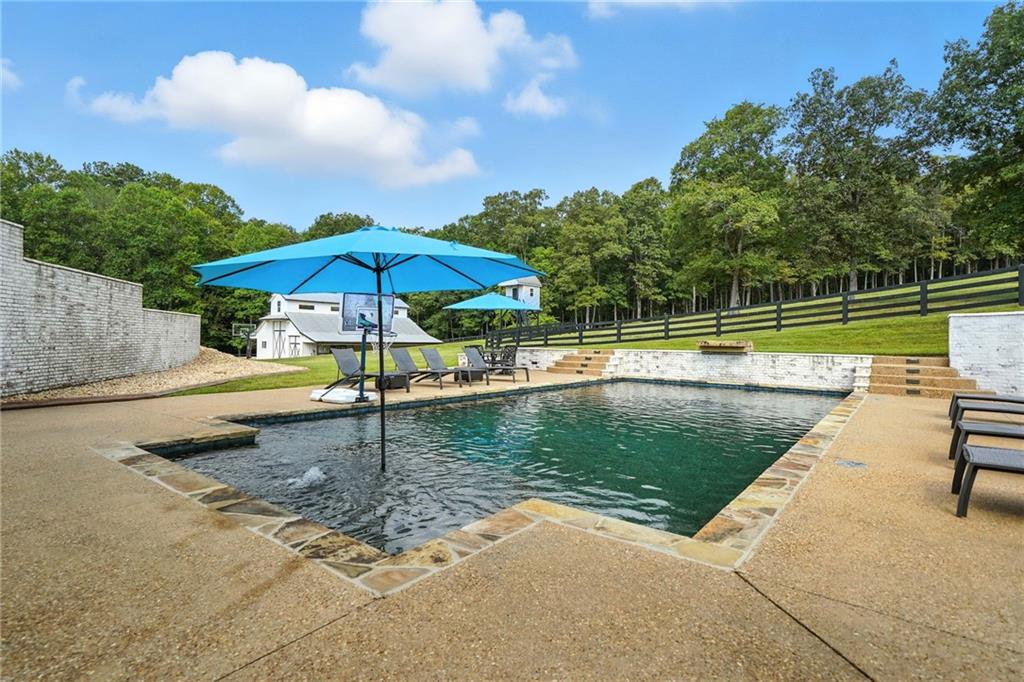 2229 Long Road Ball Ground, GA 30107 - Photo 64 of 88 a swimming pool with an outdoor seating and trees