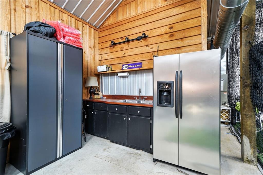 2229 Long Road Ball Ground, GA 30107 - Photo 72 of 88 a kitchen with stainless steel appliances granite countertop a refrigerator and a sink